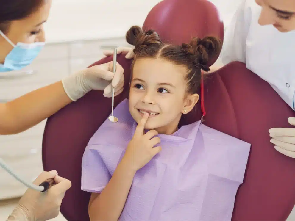 a child smiling at the dentist in Saginaw TX